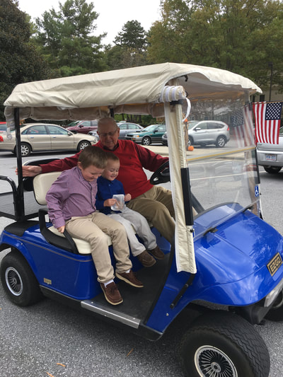 Pastor Don Taws gives the boys a ride in his golf cart.